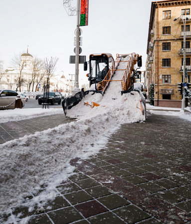 sidewalk cleaning in winter after snowfall. municipal servicesの写真素材