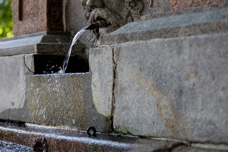 Spring of water flowing through a fountain. Crystal clear drinking waterの写真素材