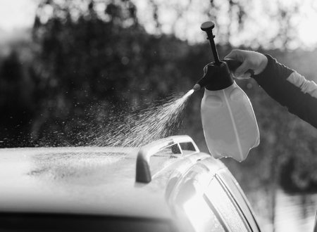 Outdoors car washing. Cleaning car using high pressure water.の写真素材