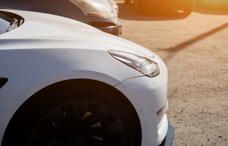 white all electric car. close-up headlight of the autoの写真素材