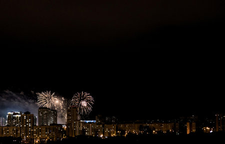 Skyline with fireworks light up sky over buildingの写真素材
