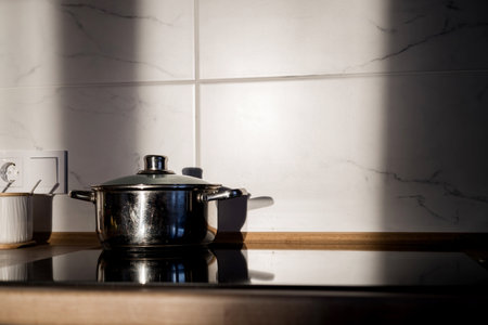 pot on a stove on sunset. contemporary glass ceramic cookerの写真素材