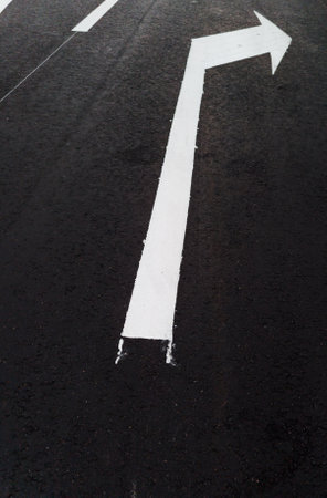 White arrows and lines, road marking on asphaltの写真素材