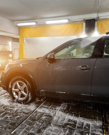 Cleaning Car Using High Pressure Water. Modern indoor car washingの写真素材