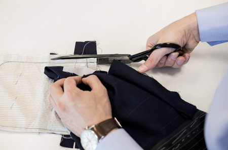 tailor using scissors. Process of making clothes in atelier. Fashion and hand craft concept.の写真素材