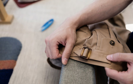 Elegant Tailor works with pants in atelier