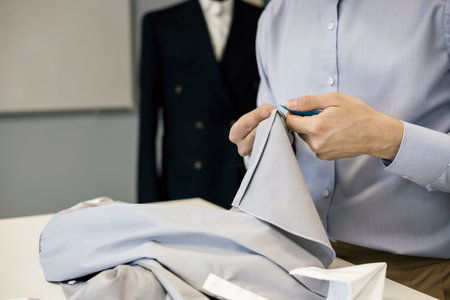 elegant tailor in suit shop fitting clientの写真素材