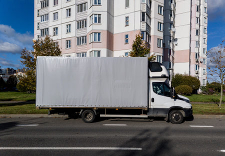 white truck standing on the road against the background of city streetの写真素材