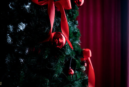 Festive christmas tree with red ribbons and baubles. tradition decorationの写真素材
