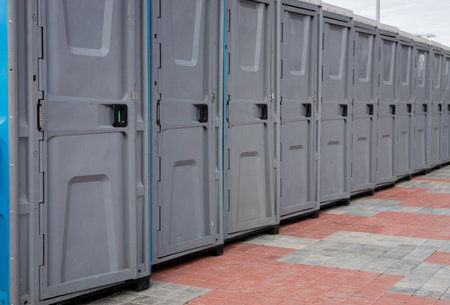 Row outdoor portable plastic toilets. Public WCの写真素材