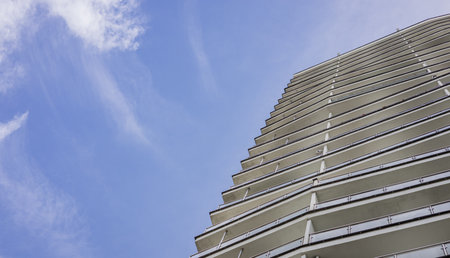 Bottom view of modern buildings on a sunny day with a blue sky. Facade of luxury architectureの写真素材