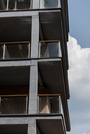 Contemporary apartment building with glass balconies and minimalist concrete structureの写真素材