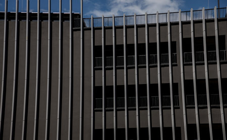 modern facade of the building is dark gray with vertical metallic slatsの写真素材