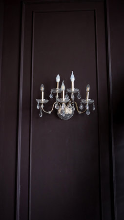 Luxury chandelier on classic wall. Old fashioned lamp