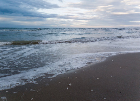 Sea coastline with sandy beach under a cloudy sky. peace and tranquilityの写真素材