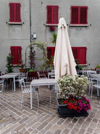 Tables and chairs in outdoor cafe. Summer terrace with flowersの写真素材