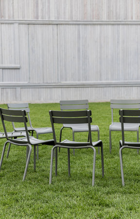 metal public seats on lawn. Modern chair on grassの写真素材