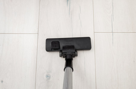 modern vacuum cleaner on light wooden floor, top view. copy spaceの写真素材