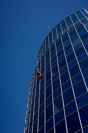 Window cleaner. Construction worker cleaning glass windowsの写真素材