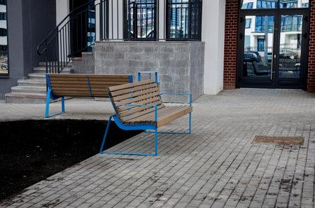 wooden bench near a residential building. a place to relaxの写真素材