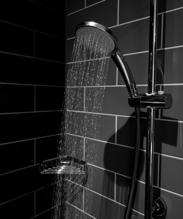 Water streaming from shower head. black and white imageの写真素材