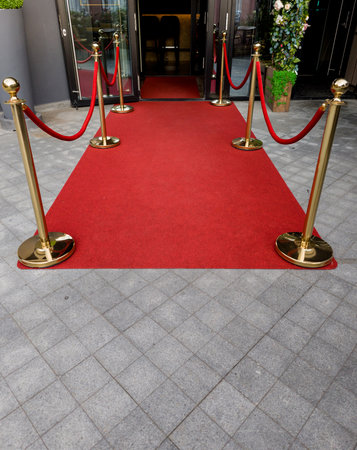 Elegant red carpet with velvet ropes. festive scene for event.の写真素材