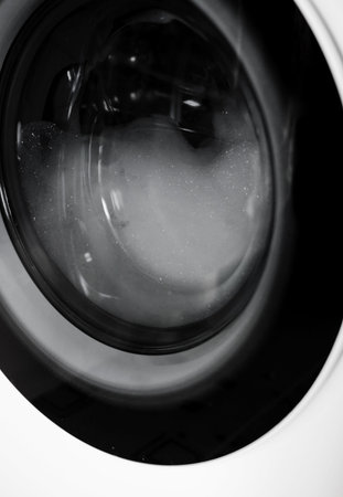 Automatic Washing Machine with foam and bubbles. black and white photo