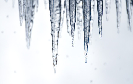 Sharp icicles dripping with water behind Niagara Fallsの写真素材
