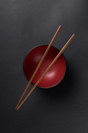 Chopsticks on Top of a Chinese Rice Bowl Dishの写真素材