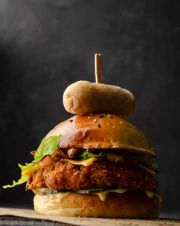 Delicious cheeseburger on black backgroundの写真素材