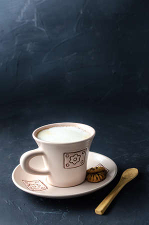 Girl's hands with empanada typical food from Venezuela adding gasacaca sauce, trio sauce, woodwn tableの写真素材