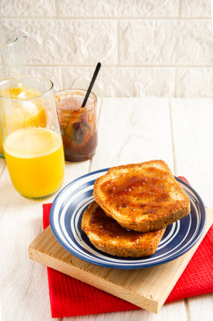 Toast with jam and orange juice. White background.の写真素材