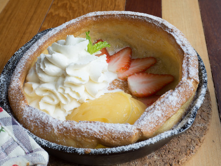 mini pancake with lemon curd and strawberry slices in a pan in Dutch styleの写真素材