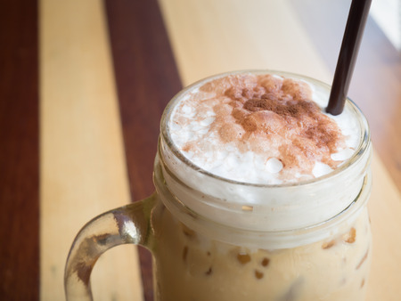 milk foam in a glass of iced cappucinoの写真素材