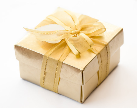 Selective focus on a gold ribbon gift boxの写真素材