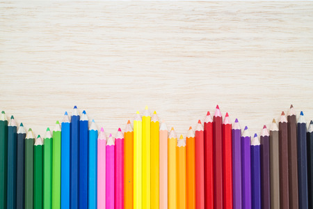 Color pencils wave on wood backgroundの写真素材