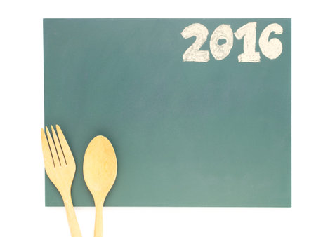 Isolated 2016 and wood spoon and fork (cutlery) on blackboard for diet food menu