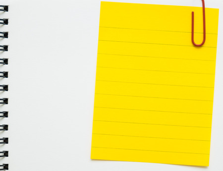 Yellow line memo paper clipped on white spiral notebook - line paper clipped on white binder notepadの写真素材