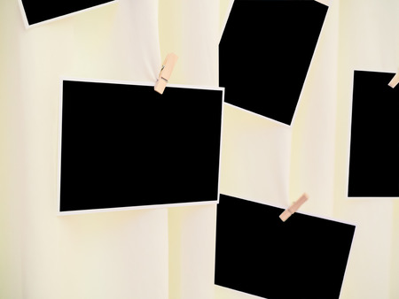 Instant photo frames hang on the light yellow curtain (selective focus)の写真素材