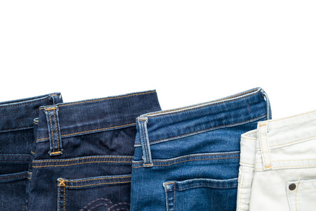 Isolated folded jeans denim trousers in different blue color from light to dark on white backgroundの写真素材