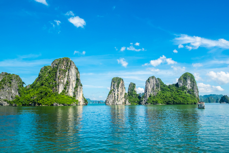 Scenic view of island in the blue ocean on a sunny blue sky - travel destination in Vietnam (Halong Bay)の写真素材