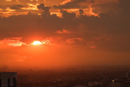 Beautiful orange dramatic sky sunset twilight time in the cityの写真素材