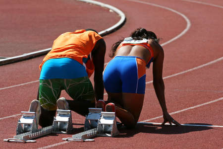 A back view from a couple ready to run, the man is the guide for a blind female runner.の写真素材