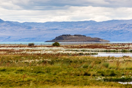 Landscape view in Laguna Nimez during golden hour. Exotic colors, beautiful lake and mountain range in the background. El Calafate, Argentinaの写真素材