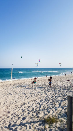 unrecognizable girls playing in a slackline at the beach, Rio de Janeiroの写真素材