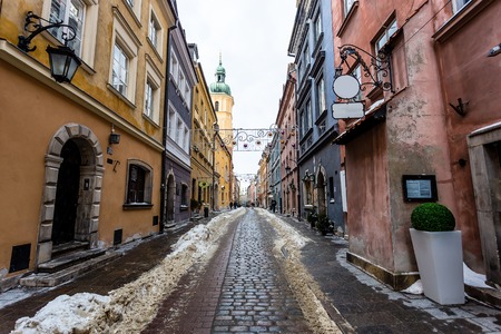 Snowy road in downtown Warsaw during january, mid winter, christmas decorations are still up.の写真素材