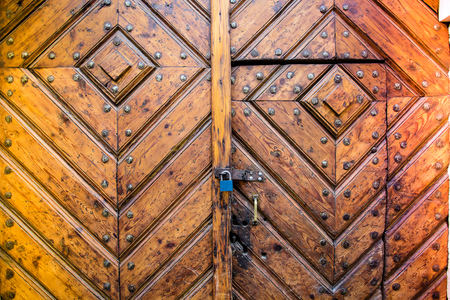 detail of old wooden door with metal lock and padlock, Krakow, Poland.の写真素材