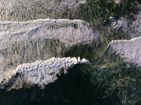 Drone photo of beach in Barra da Tijuca, Rio de Janeiro, Brazil. Waves crashing with whitewash,...