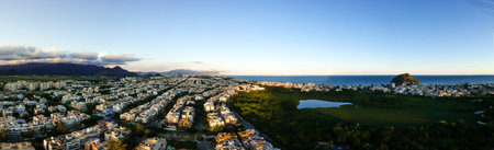 aerial panorama of Recreio dos Bandeirantes during sunset, with all the residential buildings forming a grid pattern, and the beach on the right.の写真素材