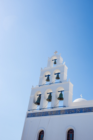 White orthodox church bell tower. Oia, Santorini Greece. Copyspaceの写真素材